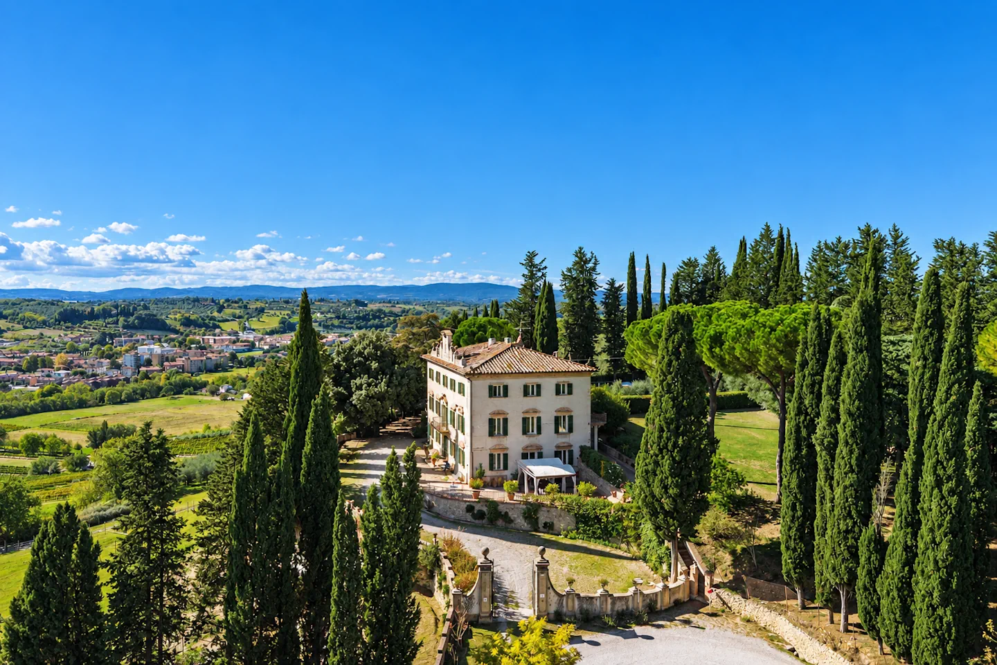 Villa Vianci surrounded by cypress trees in Tuscany